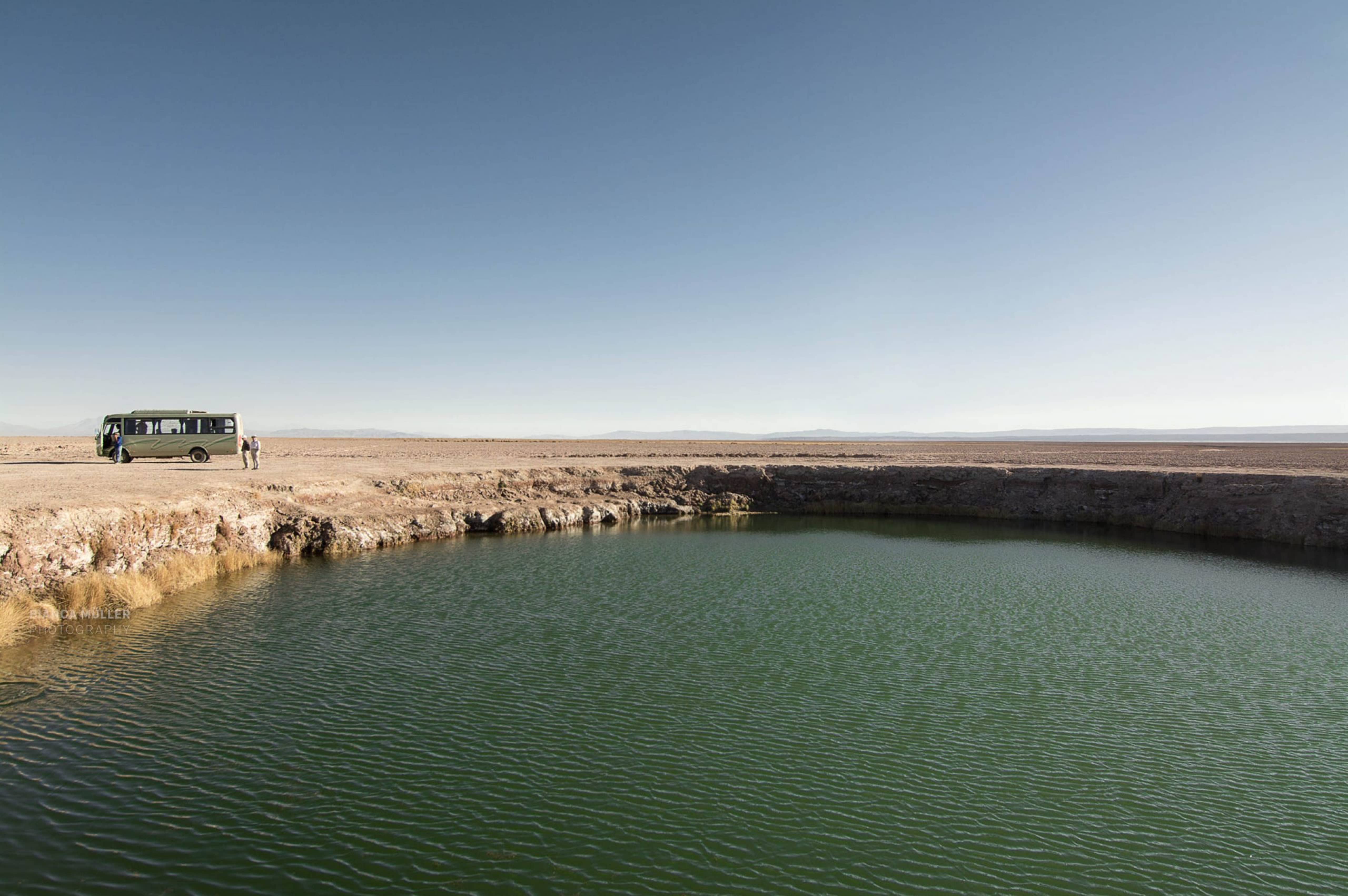 Ojos del Salar and a Tourist Bus in the Background